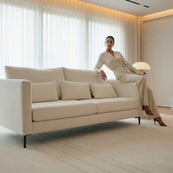 Cream three-seater boucle sofa with black metal legs in a modern living room