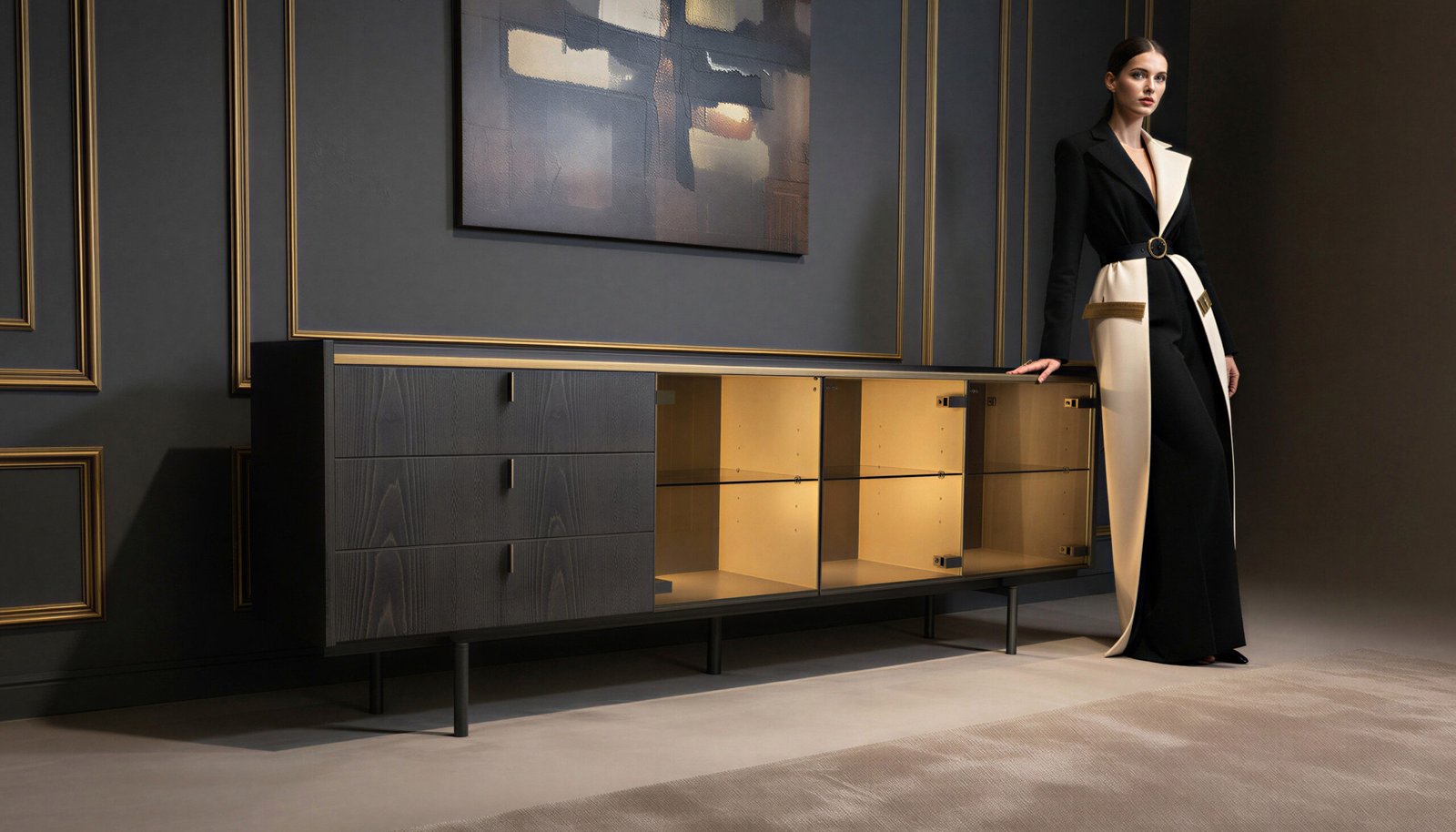 Ebonised ash sideboard with gold LED lighting in a dark styled interior with a woman standing beside it