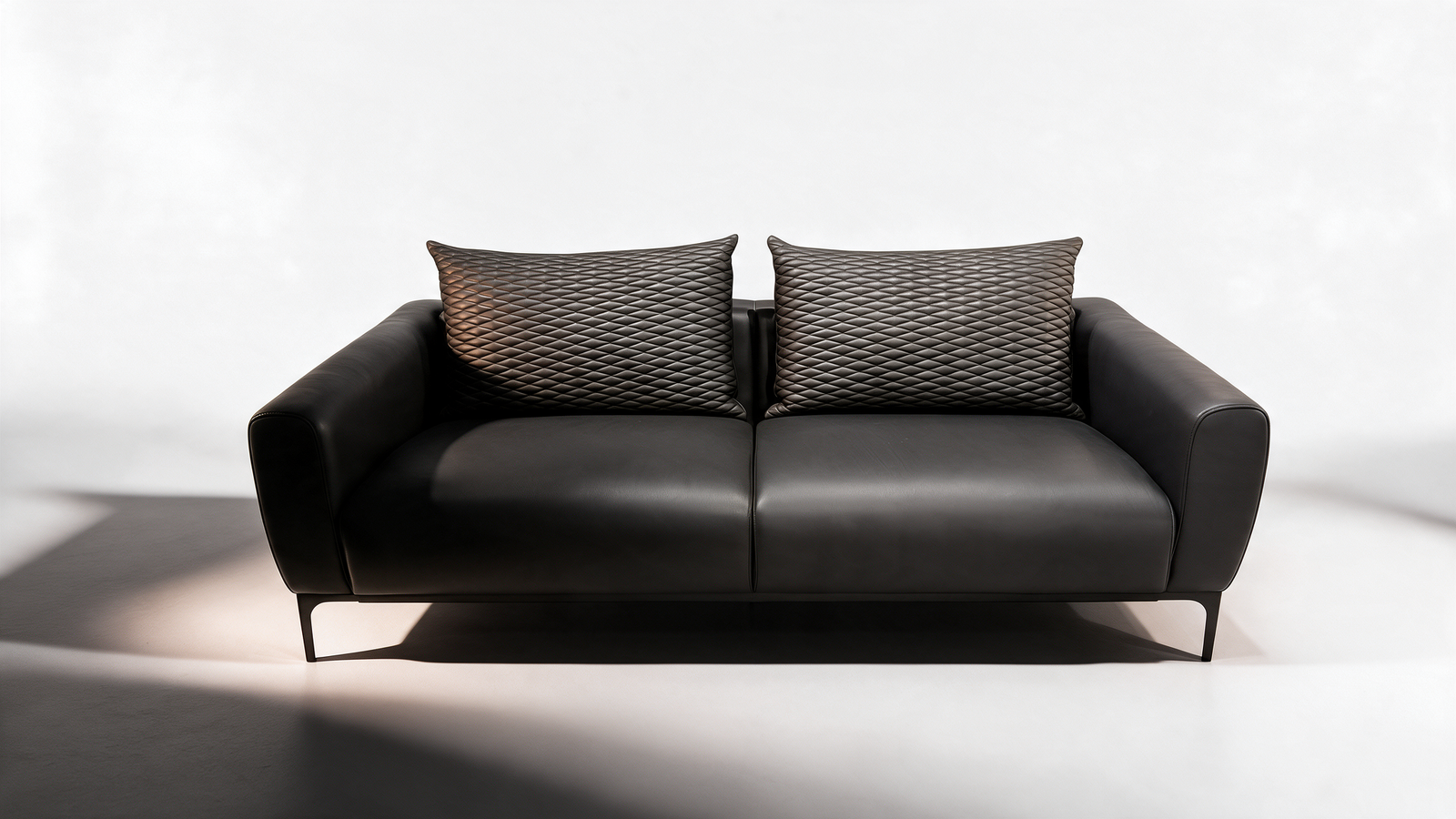 Black faux leather two seater sofa, front view