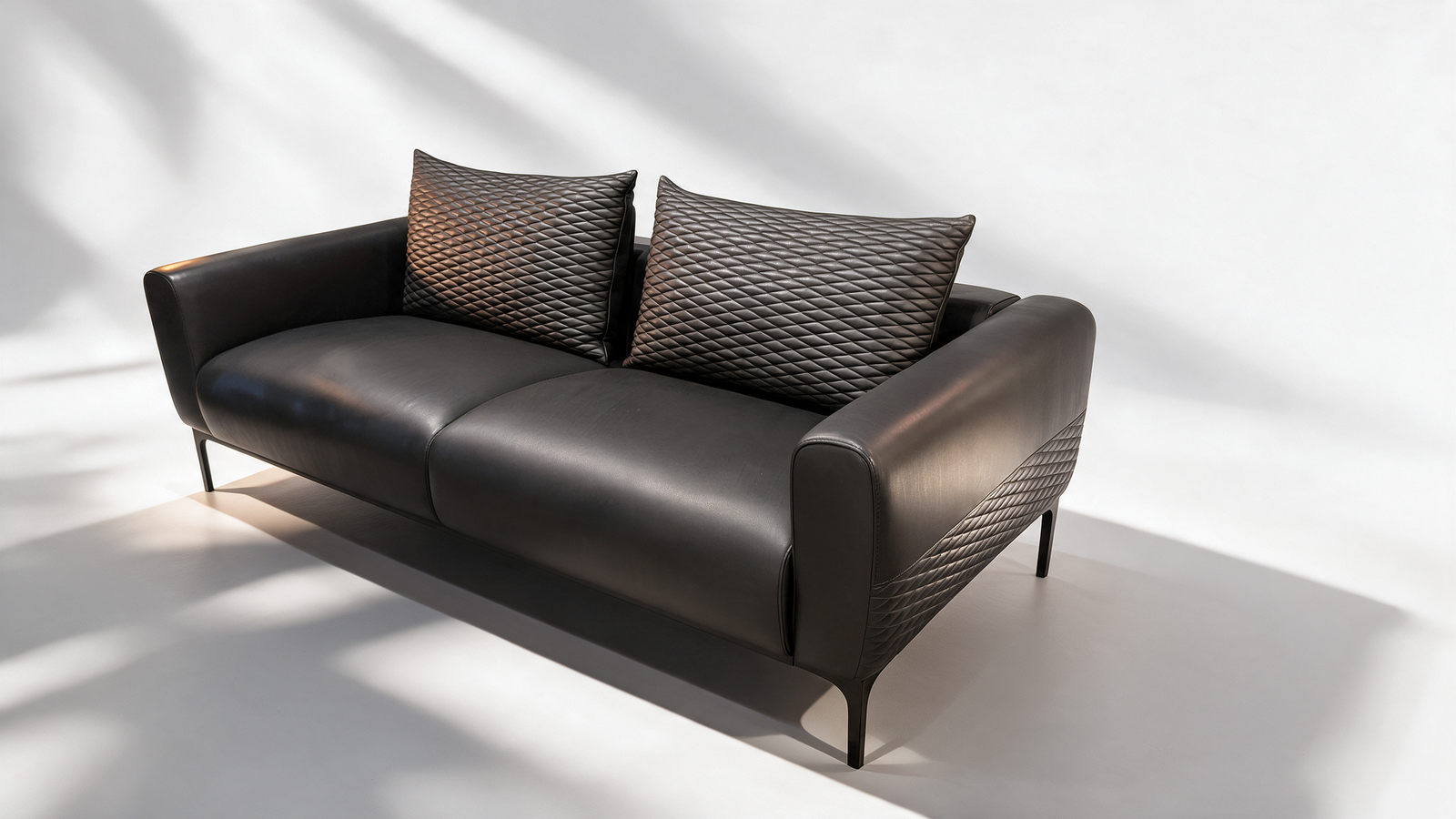 Black faux leather sofa with slim metal legs