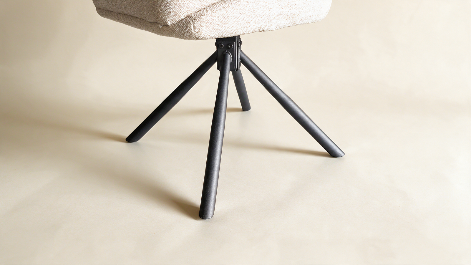 Tailored high-back swivel chair, close-up of black metal swivel base