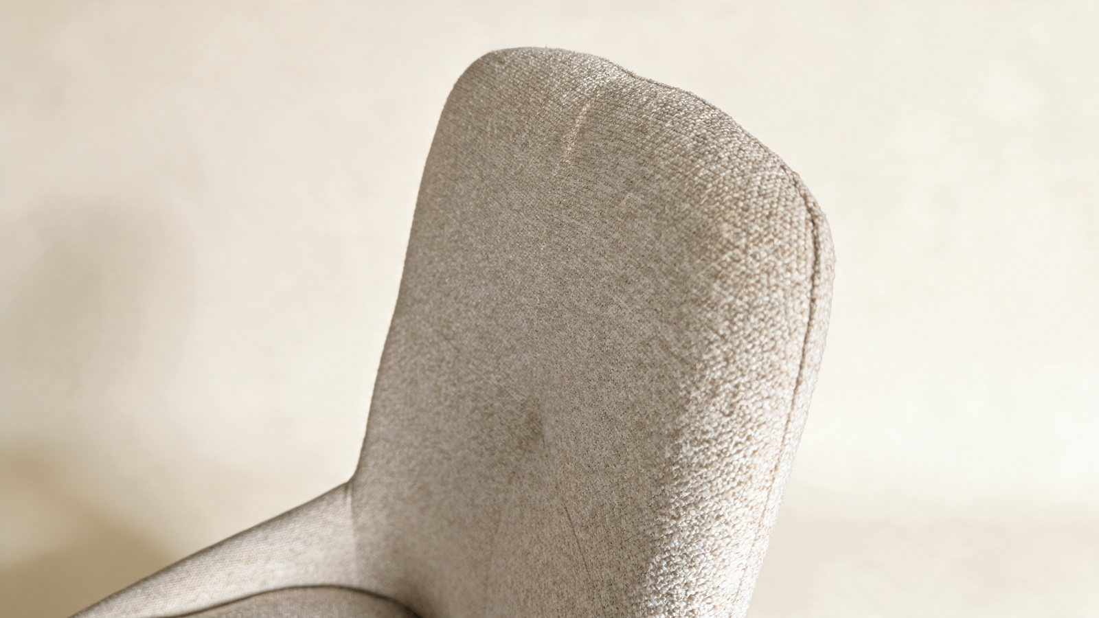 Tailored high-back swivel chair, close-up of padded grey backrest