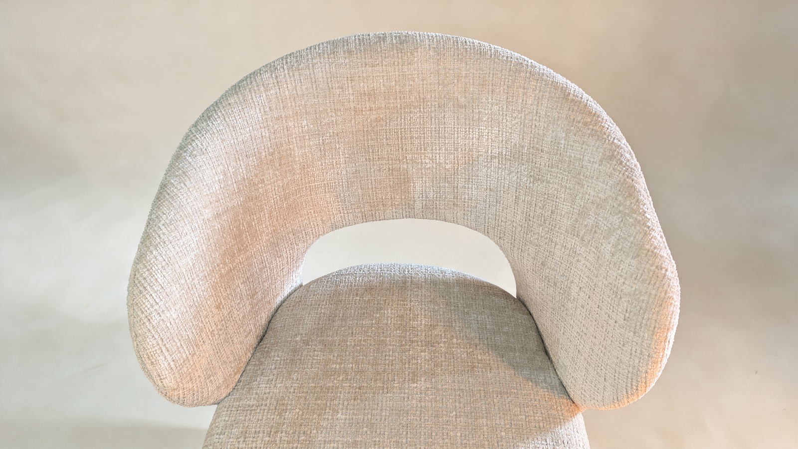 Boucle swivel accent chair with cut-out back, top-down view of curved seat