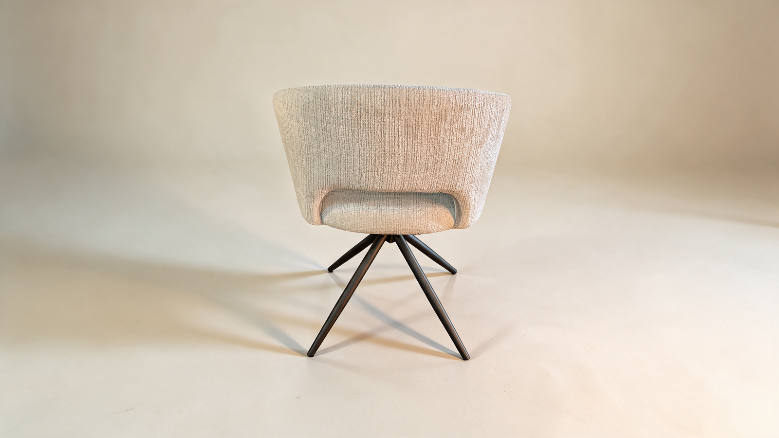 Boucle swivel accent chair with cut-out back, angled view