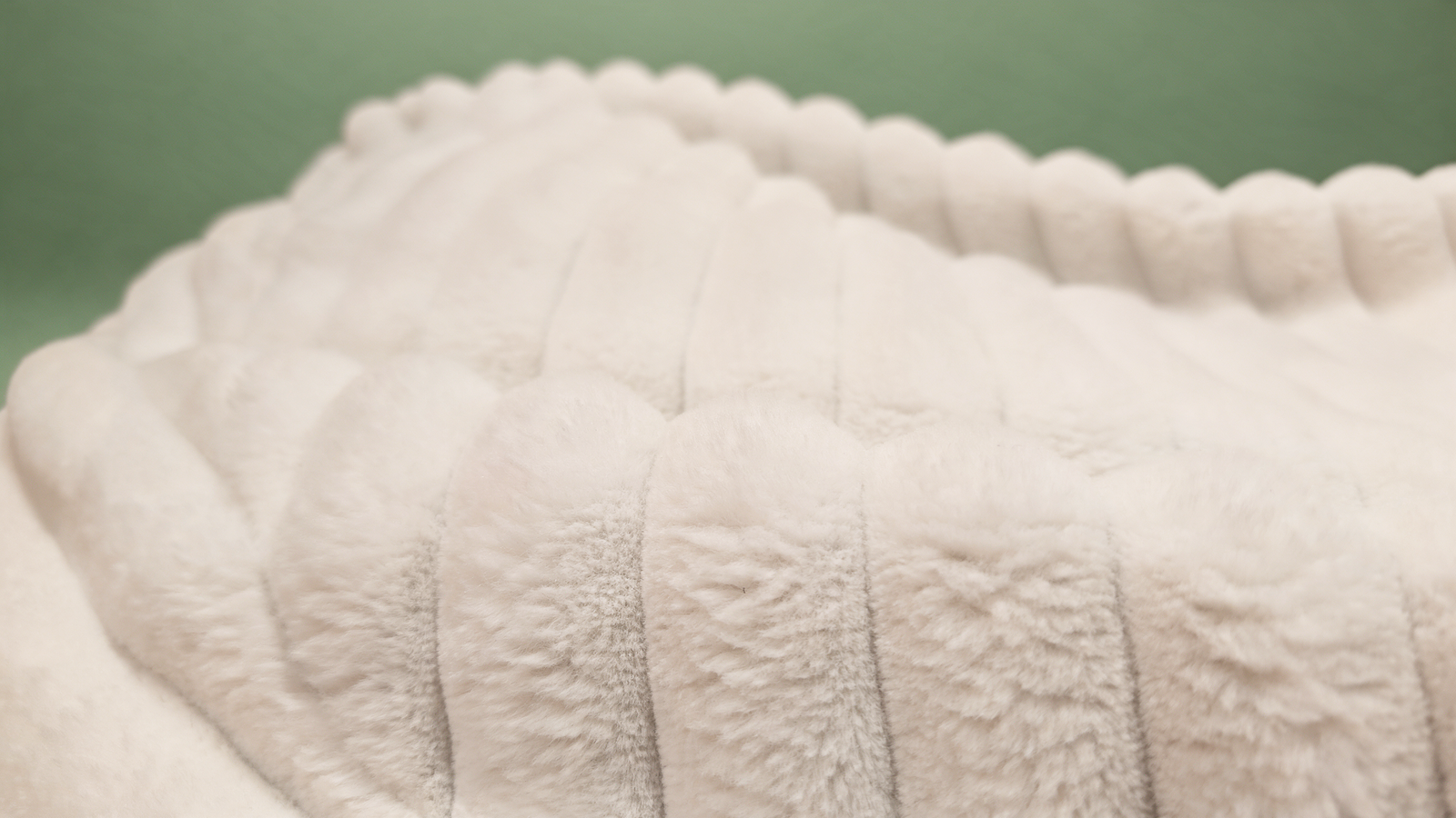 Cream ribbed faux fur bean bag, close-up of textured surface