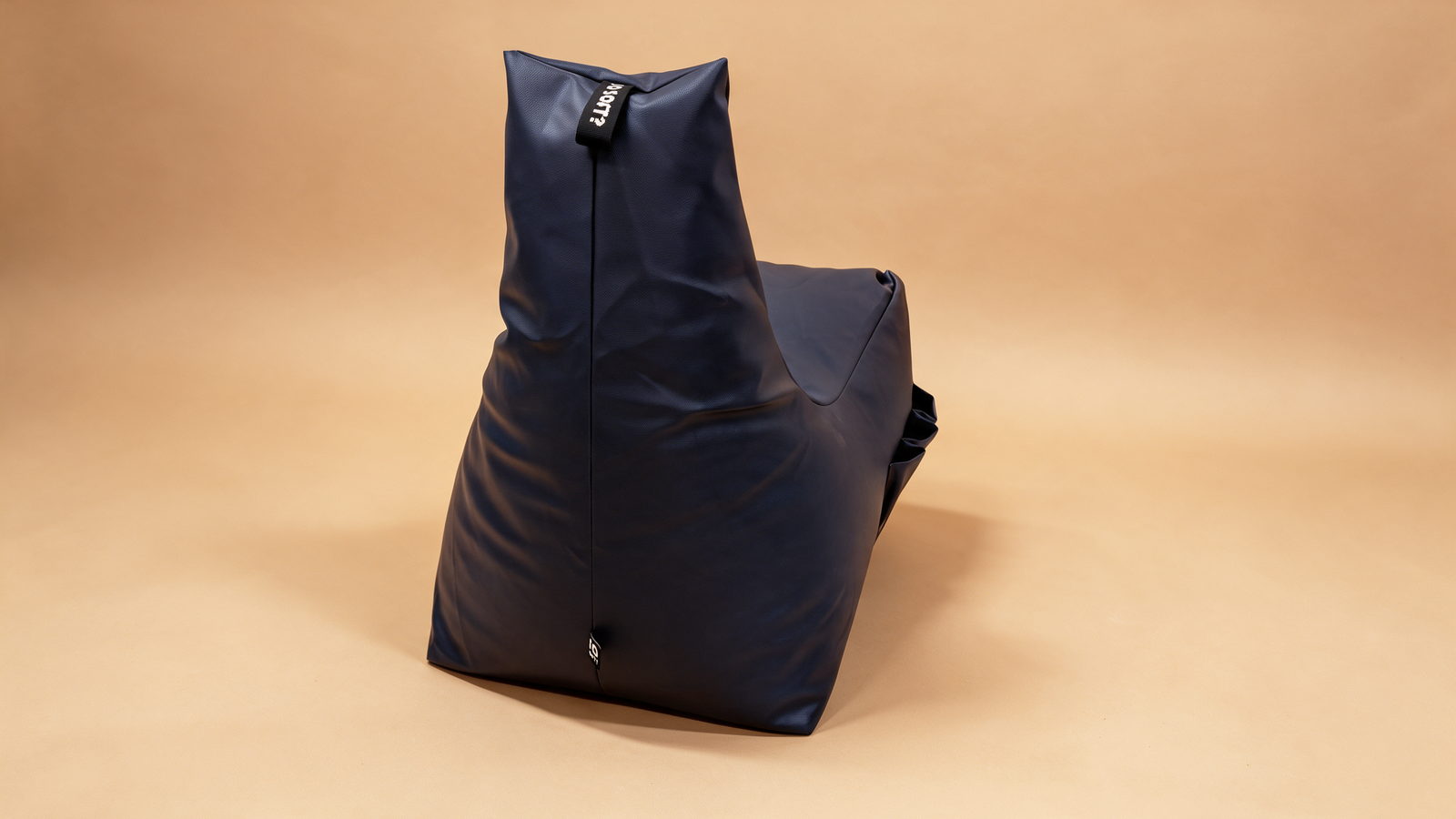 Navy bean bag lounger chair, angled side view