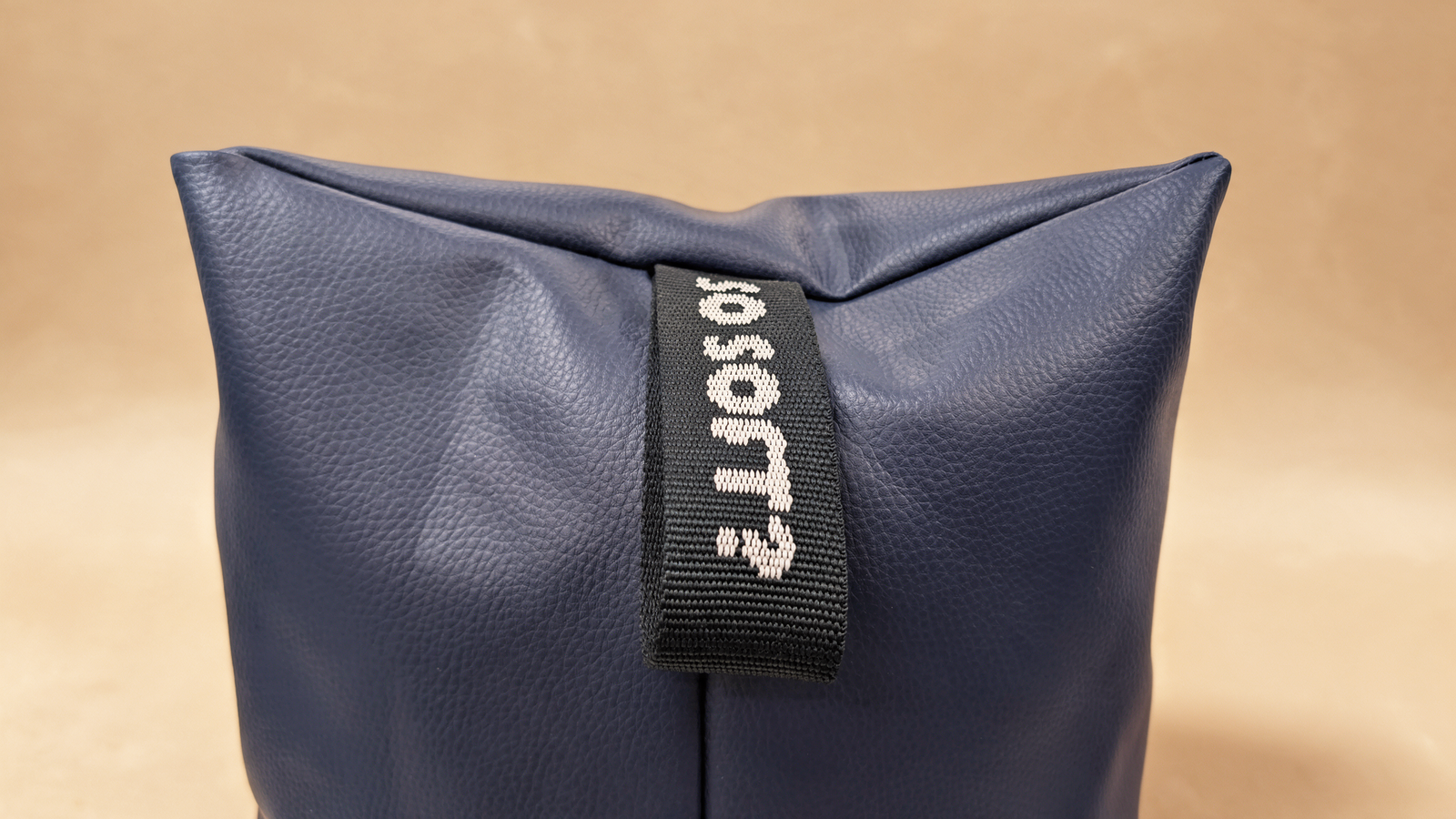 Navy bean bag lounger chair, close-up of carry handle