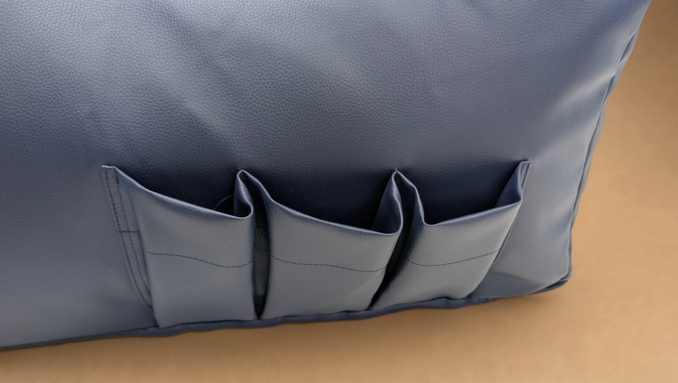 Navy bean bag lounger chair, close-up of side storage pockets
